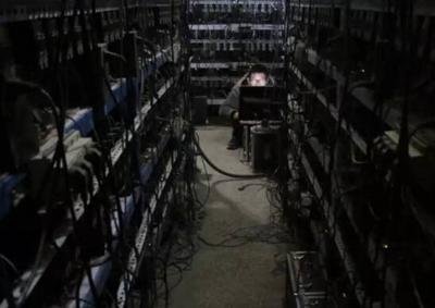 A large-scale mining farm with rows of mining rigs, showing the scale of some Bitcoin mining operations.