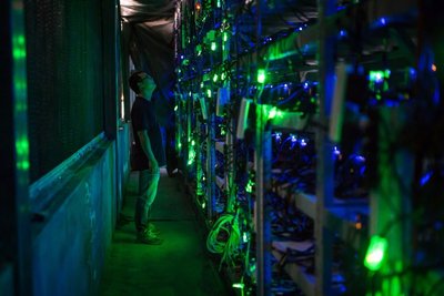 An expansive mining farm with rows of mining rigs